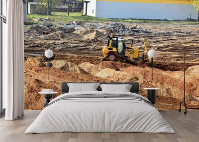 bulldozer on construction site job of burying the old building Wall mural