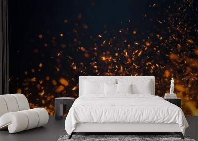 Fire embers particles over a black background. Fire sparks background. Abstract dark glitter fire particles lights. Wall mural