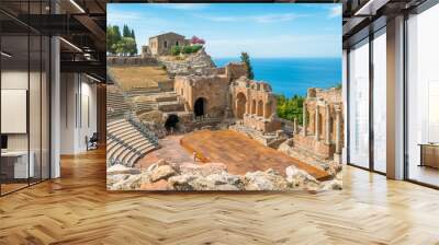 Ruins of the Ancient Greek Theater in Taormina on a sunny summer day with the mediterranean sea. Province of Messina, Sicily, southern Italy. Wall mural