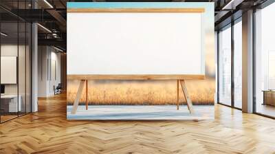 A large white board is standing in a field. The board is empty and the sky is blue Wall mural