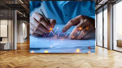 A man is writing with a pen on a piece of paper with a graph on it. Concept of analyzing data Wall mural