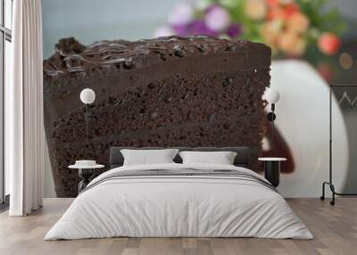 Piece of dark chocolate cake with blur flower Wall mural