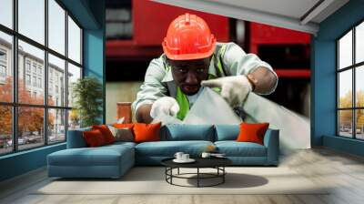 Black male african american workers wear red helmet working check up iron production in factory. Heavy Industrial manufacture workplace. Wall mural