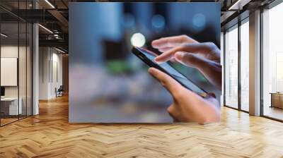 Close-up male hand using smartphone at meeting room blur bokeh background. searching data networks or chatting online. typing sending message. mockup mobile phone wireless. Wall mural