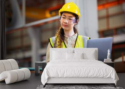 engineer female using laptop working in manufacturing factory. woman worker technician metalwork automated mechanical energy project. Wall mural