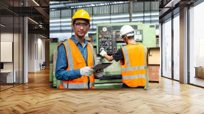 Engineering worker man wearing uniform safety and hardhat holding tablet working at factory. manager technician manufacturing. Workers industrial factory. Wall mural