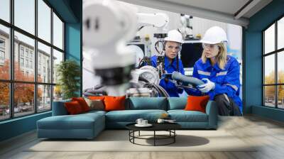 Team technician engineer using remote control automation robotics at industrial modern factory. woman working at factory innovation automation robot. Wall mural