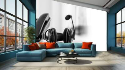 Customer service concept. Close-up headphone and telephone for communication helpdesk IT support or call center and online services. Wall mural