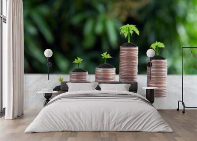 Many coins are stacked in a graph shape with growing tree for financial planning concepts. Wall mural