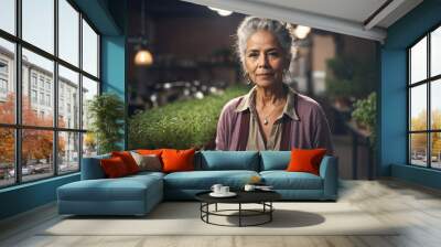 A woman in a purple sweater stands in front of a plant nursery Wall mural