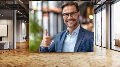 Confident smiling businessman showing thumb up gesture. Wall mural