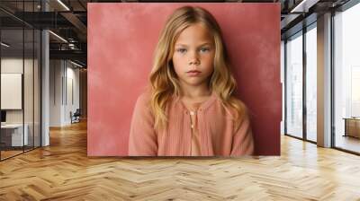 Lifestyle portrait photography of a serious child female wearing a chic cardigan against an abstract background Wall mural