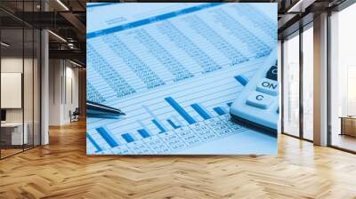 Accounting financial bank banking account stock spreadsheet data with pen and calculator in blue  Wall mural