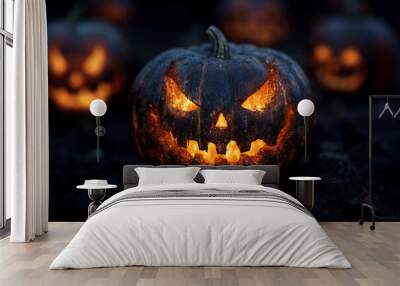 Pumpkins carved out for Halloween decorations with warm lights in the darkness Wall mural