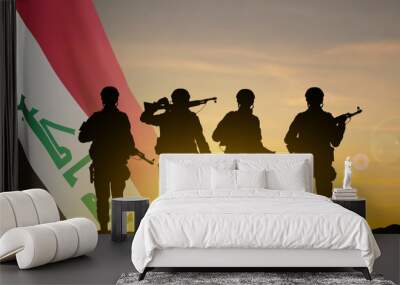 Silhouettes of a soldiers with Iraq flag against the sunset. EPS10 vector Wall mural