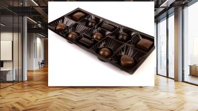 Select box of milk and dark chocolates in a shiny brown display Wall mural