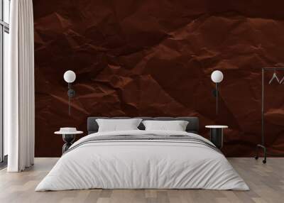 Crumpled sheet of dark brown paper texture. Creased background Wall mural