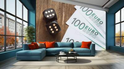 Gambling for money. Black dice and euro on a wooden table. Wall mural