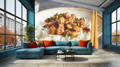 Sesame chicken pieces with rice on a ceramic plate. Chinese traditional dish. Wall mural