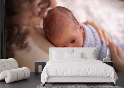 Adorable Newborn Baby Boy sitting on mother chest. Skin to Skin Wall mural