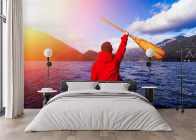 Man with Hand Up on wooden canoe are paddling in water during a vibrant sunny day. Taken in Indian Arm, near Deep Cove, North Vancouver, British Columbia, Canada. Concept: Adventure, Sport, Explore Wall mural