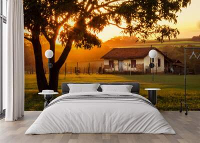 orange sunset on the farm with old house Wall mural