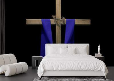 Wooden cross draped with purple fabric and thorns Wall mural