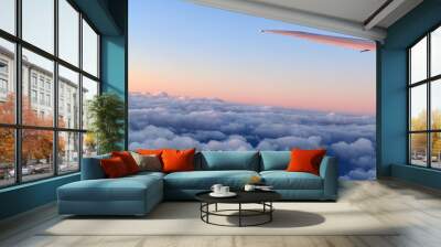 Aircraft wing above cloudscraper with horizon of pink and blue sky,view from airplane window. Wall mural