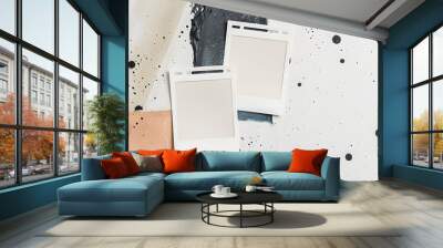 Abstract background with two blank Polaroid frames on top of a white and brown splattered canvas. Wall mural