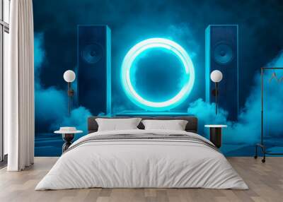 Blue neon light circle in dark room with two speakers, creating a futuristic atmosphere. Wall mural