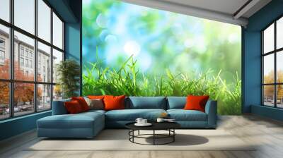 Close-up of vibrant green grass blades with a blurred background of blue and green bokeh. Wall mural