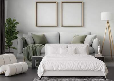 Modern living room interior with a white sofa, two empty frames, and a green plant. Wall mural