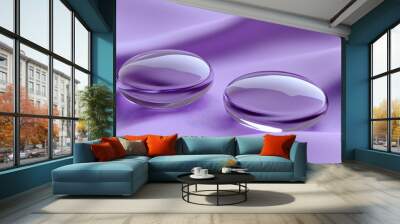 Two purple glass orbs on a purple silky fabric. Wall mural