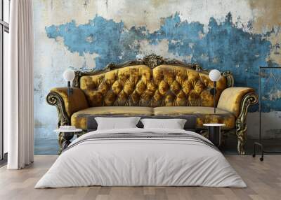 Vintage gold sofa with ornate details in front of a weathered blue and white wall. Wall mural