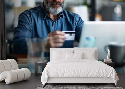  business man holding a credit card and mobile phone in an office,  Wall mural