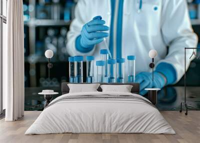 a person in a lab coat holding a test tube. The person is most likely a scientist or researcher working in a laboratory setting. The image conveys a sense of scientific experimentation and analysis. Wall mural