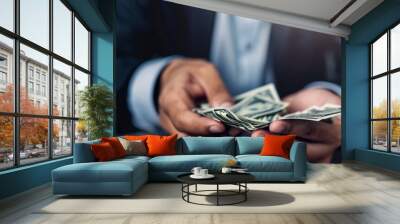 Businessman counting dollar bills with focused lighting Wall mural