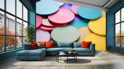 Colorful paper circles scattered across surface, abstract background Wall mural