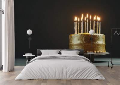 Golden birthday cake with lit candles on a dark background Wall mural