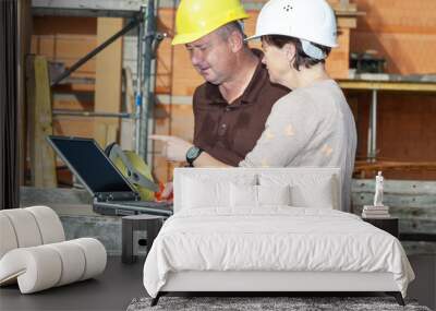 civil engineer and construction worker looking at the laptop Wall mural