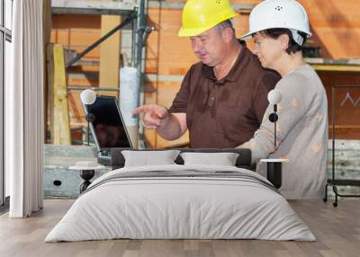 civil engineer and construction worker looking at the laptop Wall mural