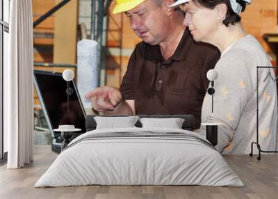 civil engineer and construction worker looking at the laptop Wall mural