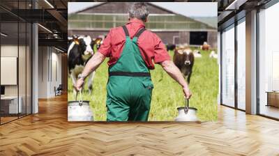 farmer with milk churns at his cows Wall mural