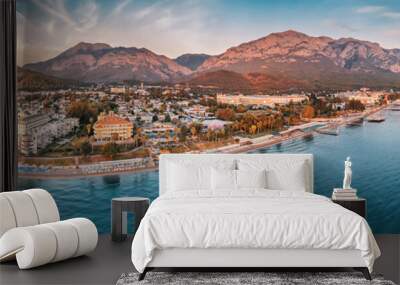 beauty of Kemer from a new perspective with breathtaking aerial view, showcasing a stunning panorama of hotels nestled amidst the scenic mountain landscape. Wall mural