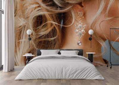 Close-up selective focus on precious jewelry earrings. Woman preparing for the event, with a chic hairdo. Wall mural