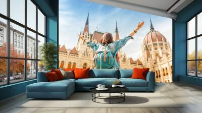 happy asian casual woman student enjoying great view of the parliament building in budapest city, tr Wall mural