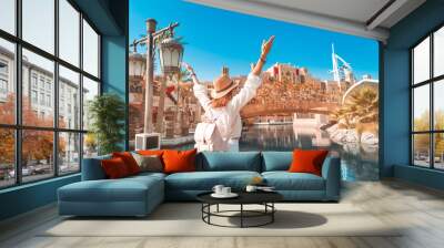 happy girl admires the beautiful view of the Madinat Jumeirah Hotel and Mall. Travel and tourism in Dubai and United Arab Emirates Wall mural