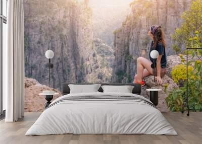 Happy traveler girl sitting on top of the Tazi canyon in Turkey. Tourist attractions and destinations Wall mural