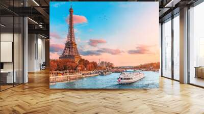 The main attraction of Paris and all of Europe is the Eiffel tower in the rays of the setting sun on the bank of Seine river with cruise tourist ships Wall mural