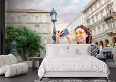 Tourist asian girl making photos on her smartphone, travel and vacation concept Wall mural